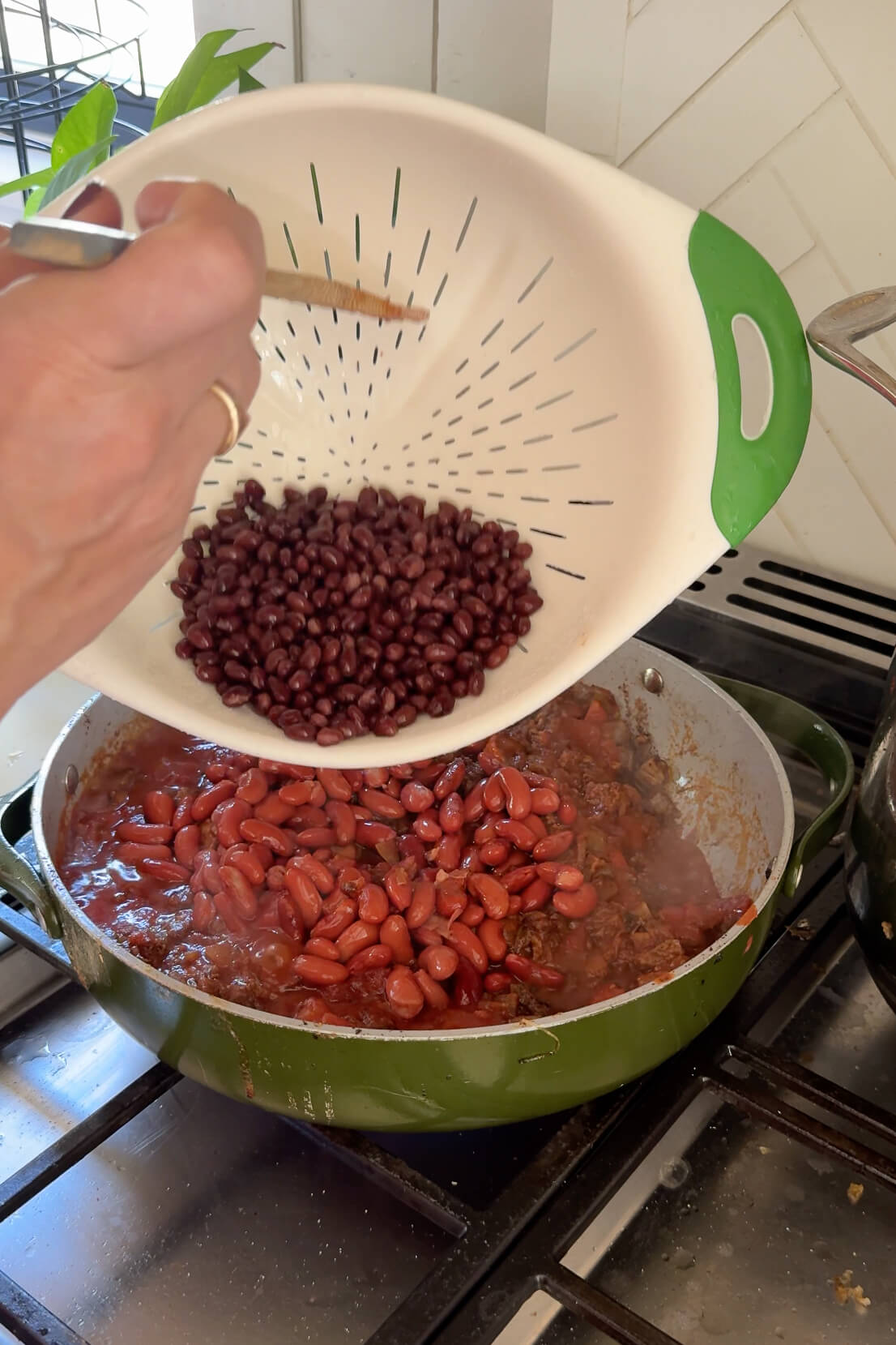 Adding beans to my brisket chili.